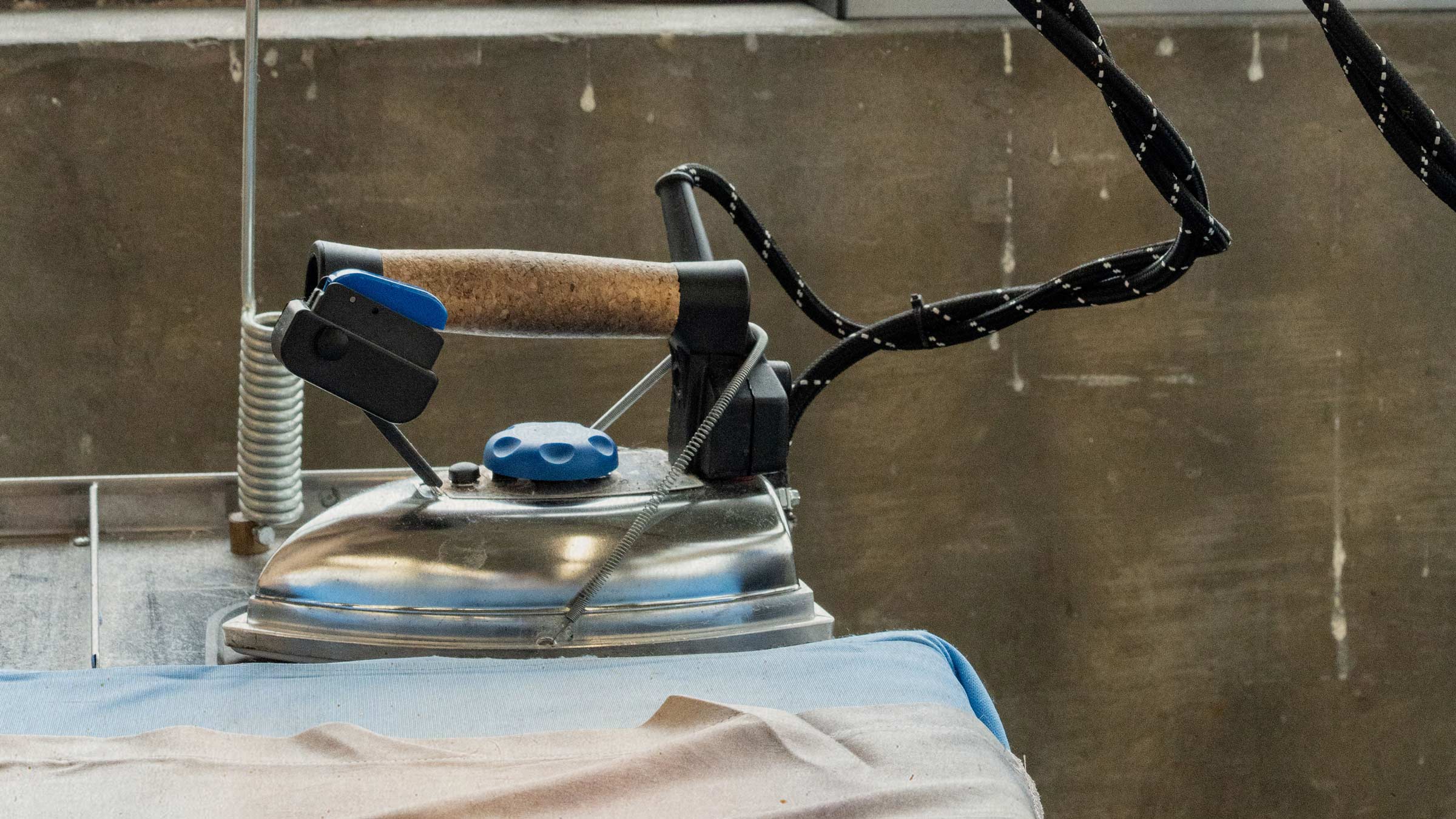 A professional steam iron at a London garment maker's workshop — bespoke clothing made in the UK by Saywood