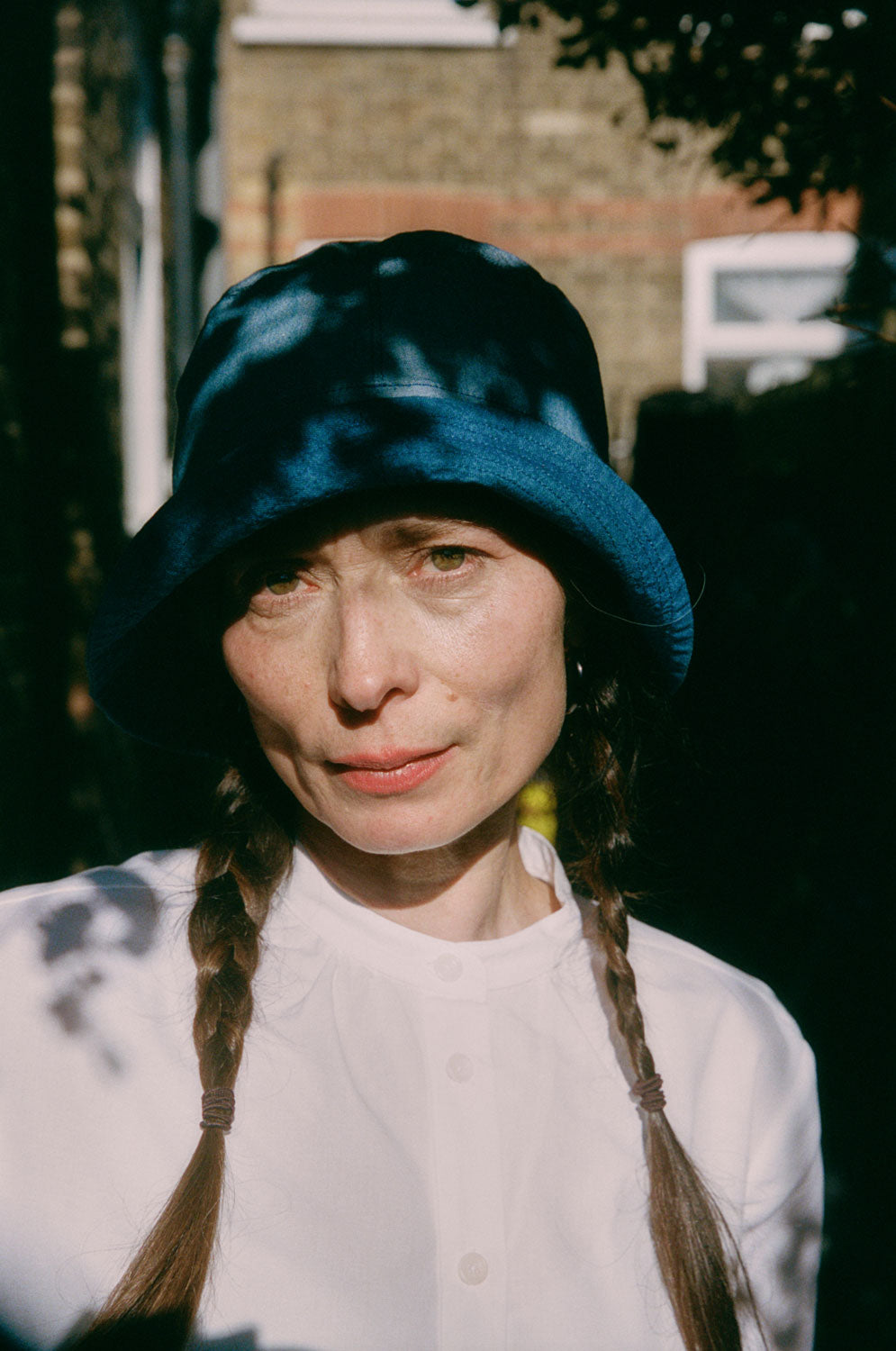 Reversible Japanese denim bucket hat worn light wash side out, with indigo contrast brim, by Saywood