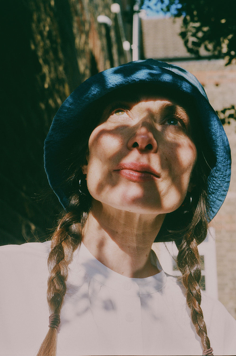 Close-up of reversible Japanese denim bucket hat, light wash worn with indigo contrast detail, by Saywood