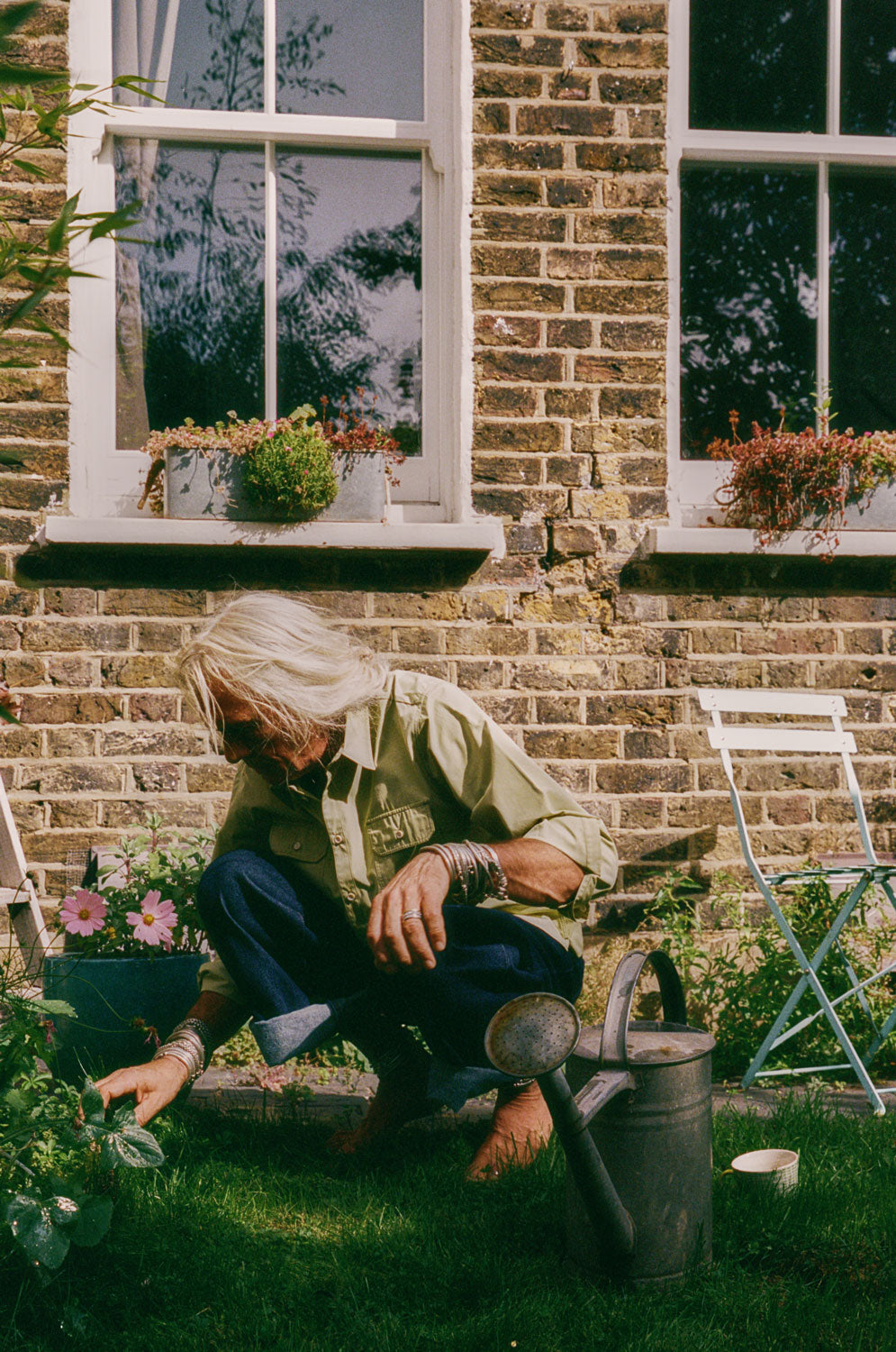 Styling inspiration: Eddy men's khaki utility shirt in heavyweight cotton, relaxed fit, made in East London by Saywood. Worn with rolled-up indigo jeans.