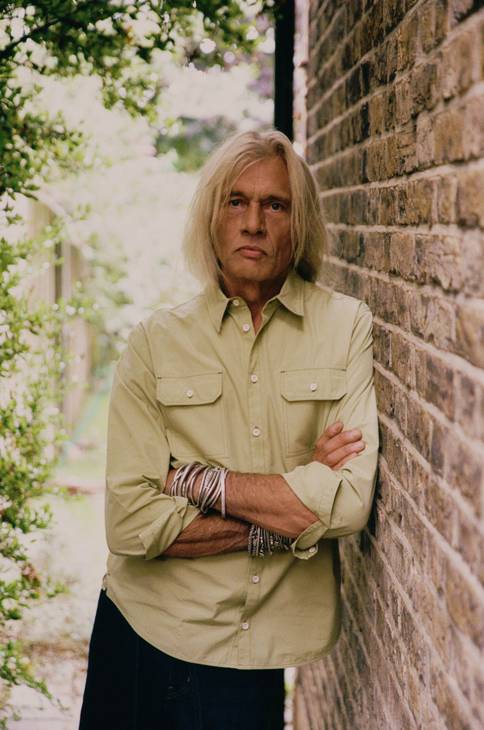Eddy men's limited edition utility shirt in khaki cotton, relaxed fit, handmade in East London by Saywood. Worn with dark indigo jeans.
