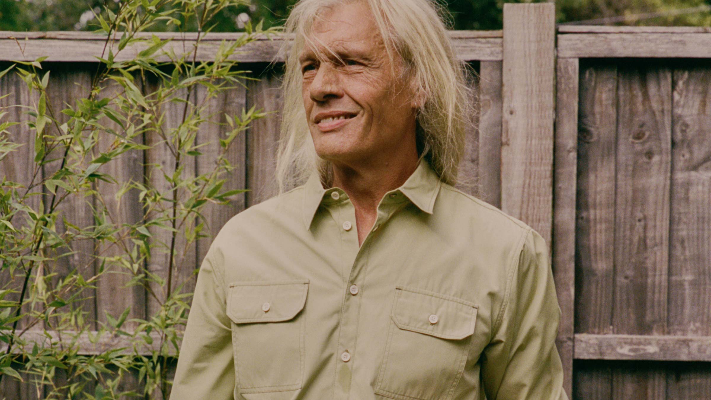 Eddy Utility Shirt in olive, worn relaxed in a garden setting — sustainable menswear made in England by Saywood