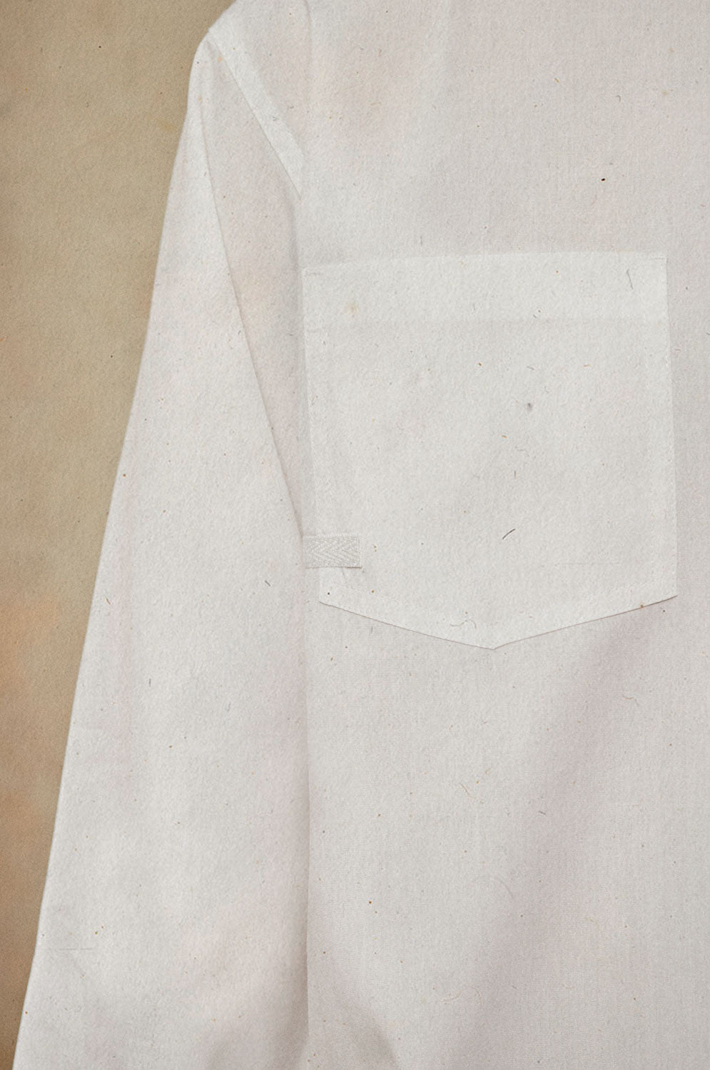 Detail view of Eddy white shirt patch pocket with cotton herringbone tape trim and topstitching by Saywood