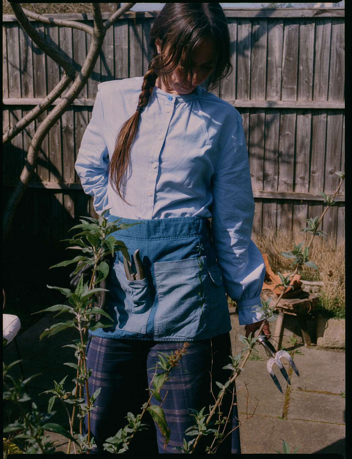 Japanese denim gardener's apron with garden tools, styled with Marie blouse and navy check Amelia trousers by Saywood