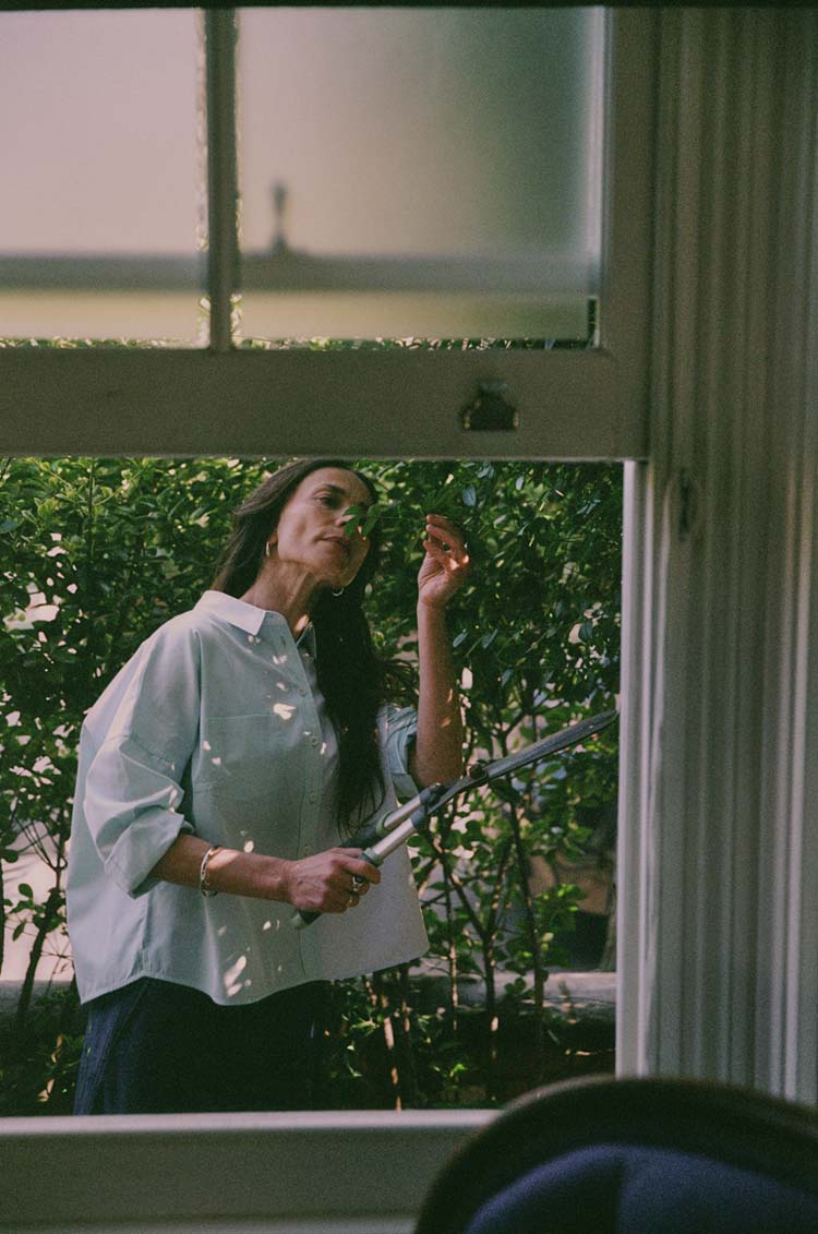 Lela Boxy Shirt in green and blue cotton colourblock, worn outdoors in dappled garden light — made in the UK by Saywood