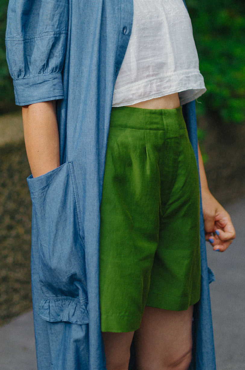 Detail of Bessie tailored shorts waist and pocket in rich olive green deadstock linen cotton by Saywood