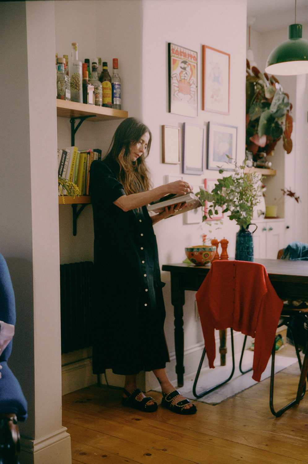 Lifestyle shot: Rosa puff sleeve shirtdress in black Japanese denim with chunky sandals, made in London by Saywood