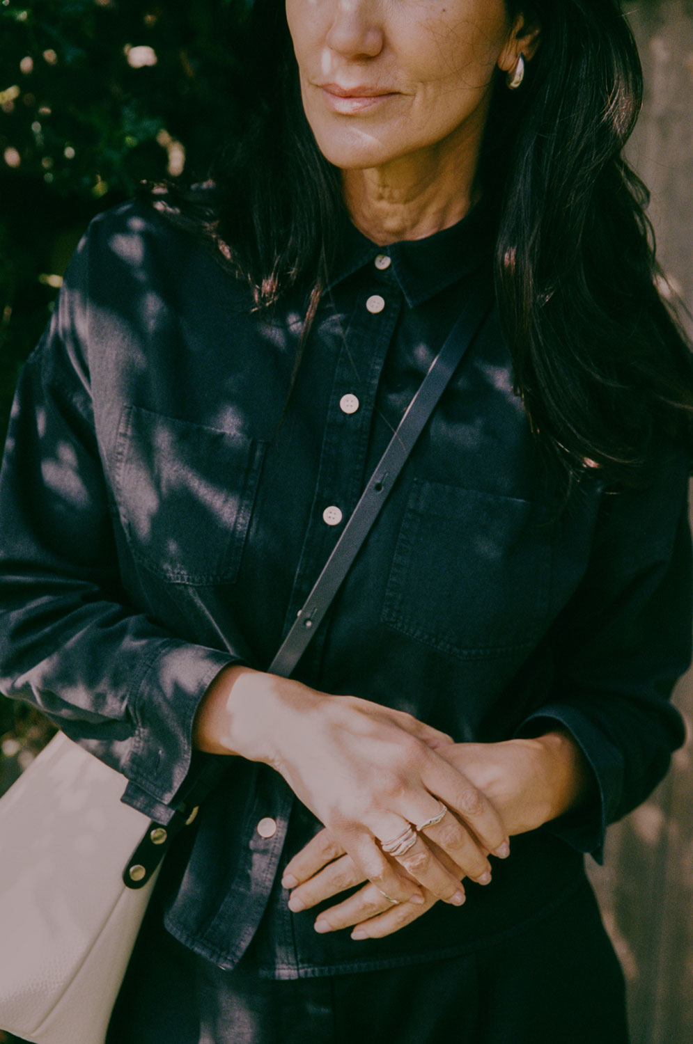 Detail of Lela black shirt showing defined topstitching and self-trim pocket tabs, premium Japanese denim