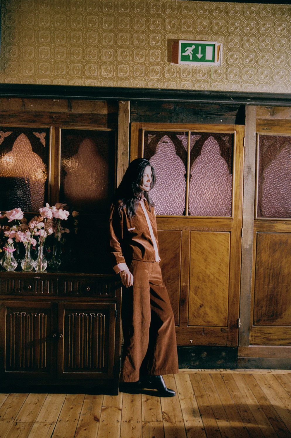 Side view: Amelia full length trousers in caramel corduroy with pink colorblock Lela shirt by Saywood