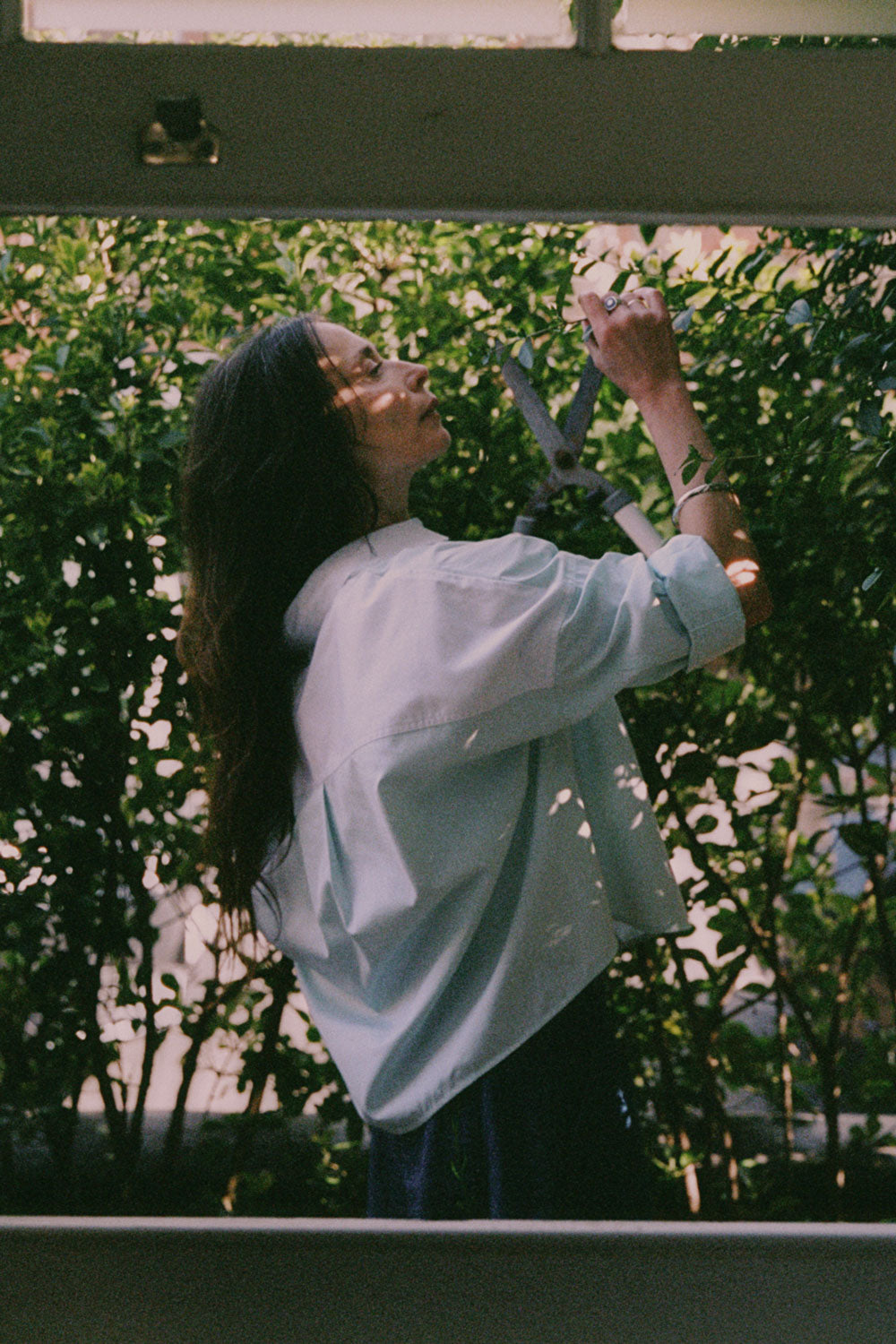 Styling inspiration: Lela pastel green blue colourblock shirt with rolled sleeves, outdoor lifestyle shot by Saywood