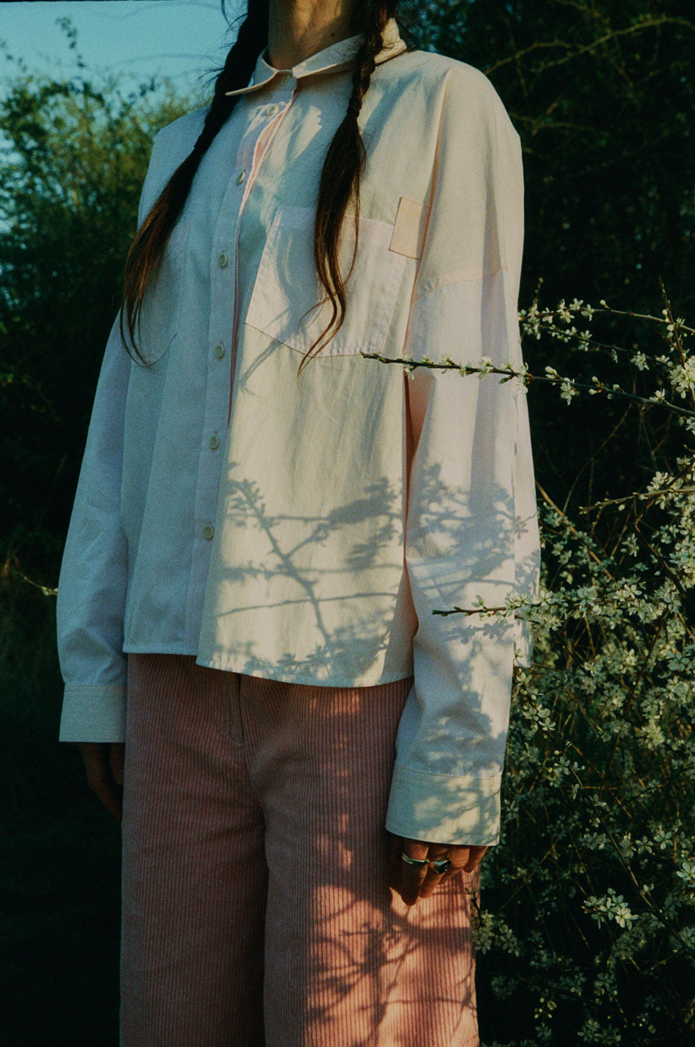 Close-up detail of Lela pink orange colourblock shirt showing patch pocket with herringbone tape detail by Saywood