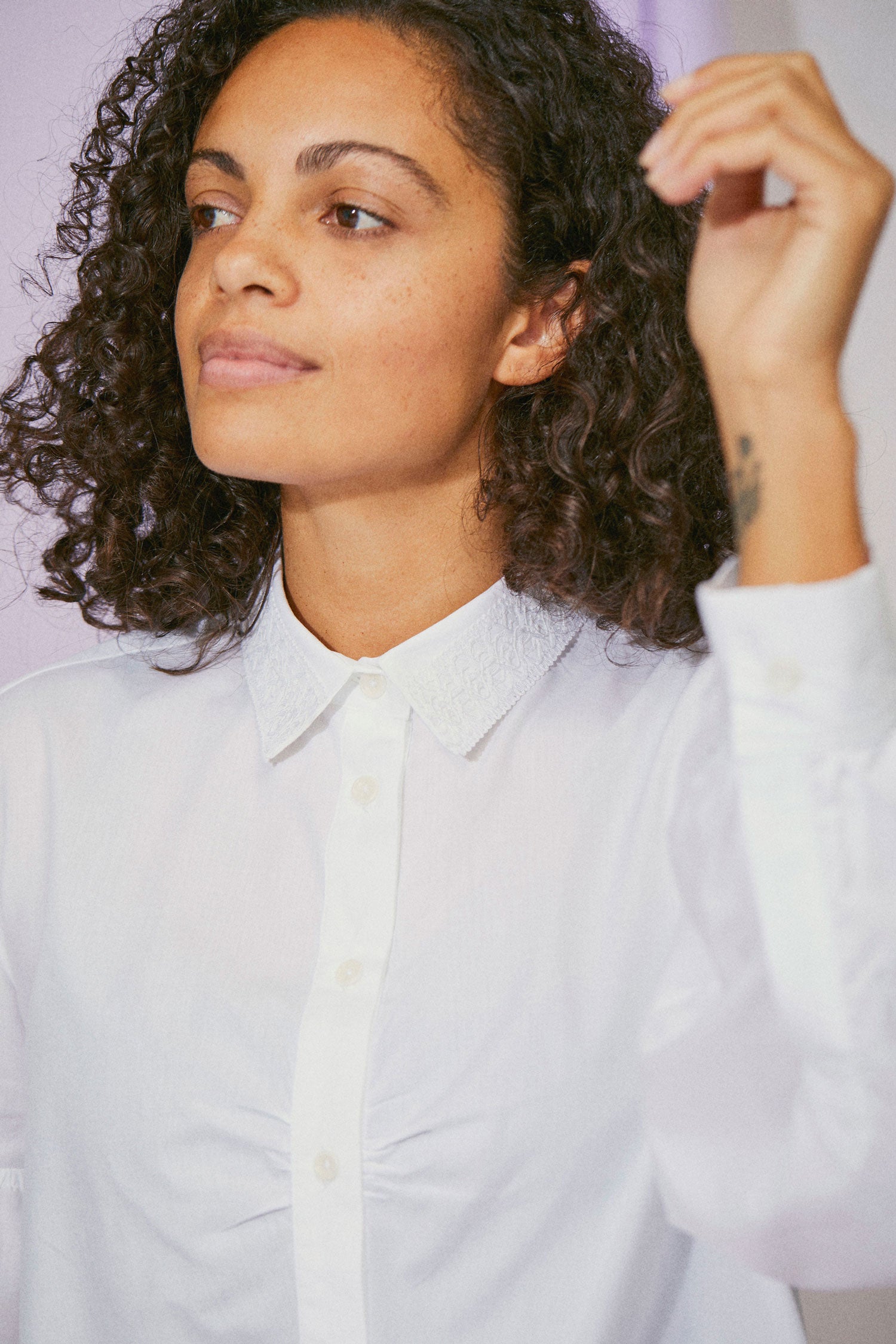 Close-up of Edi white shirt showing lace collar and volume sleeve detail