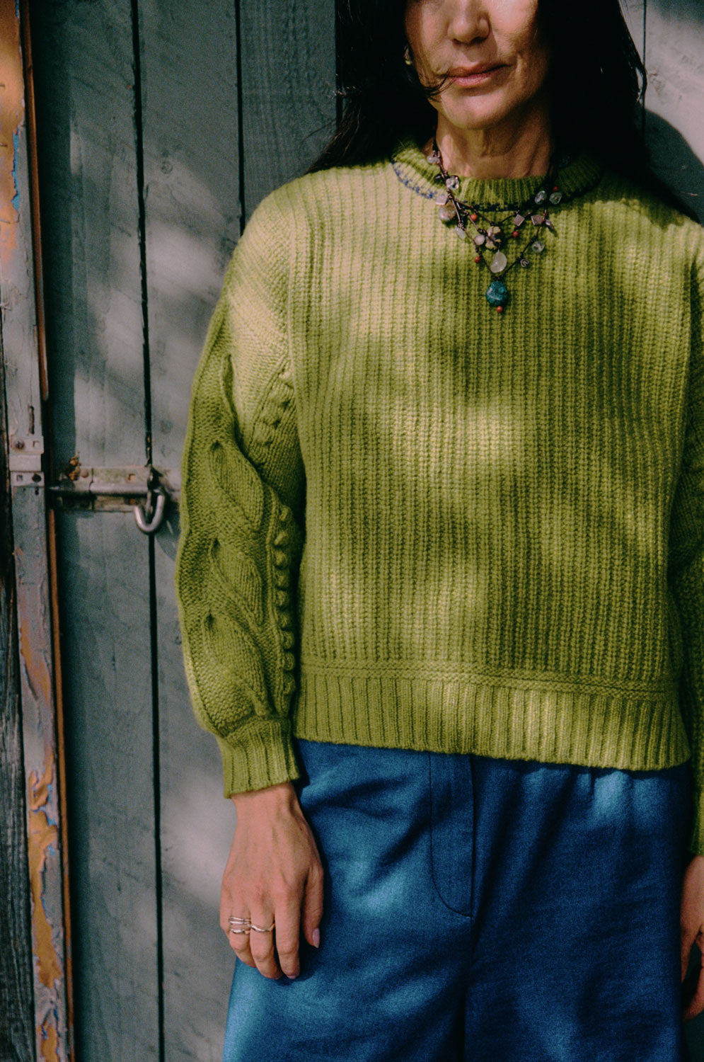 Close-up of Adams sweater textured balloon sleeve with hand-finished leaf detail, Scottish lambswool