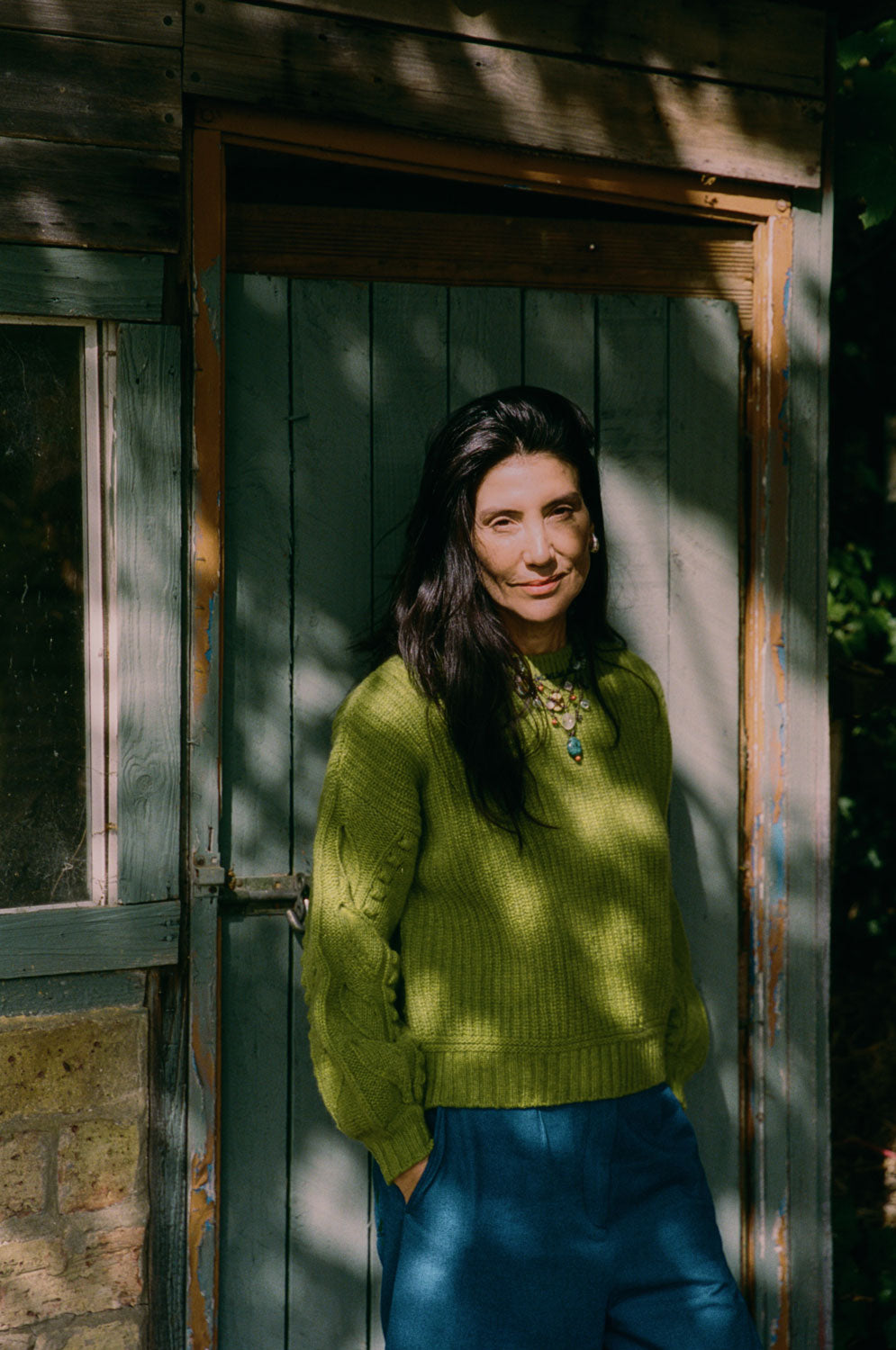 Detail shot of Adams moss green sweater hand-finished balloon sleeve with leaf design, Scottish-spun lambswool