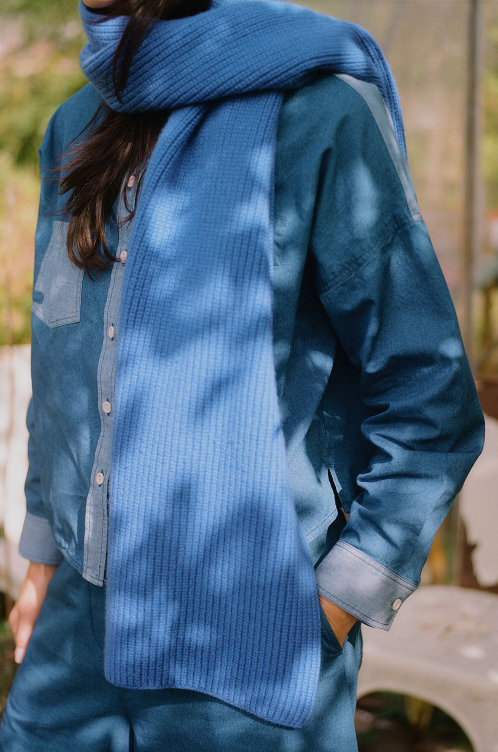 Lela boxy indigo Japanese denim shirt styled with scarf and layered accessories