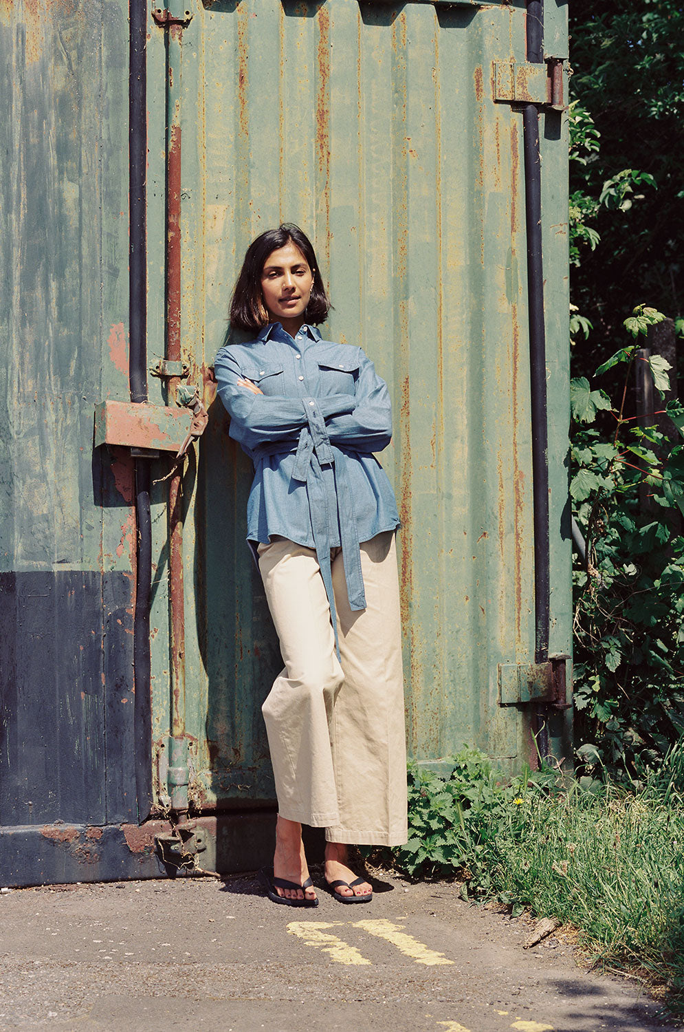 Full outfit view: Zadie oversized Japanese denim shirt with beige trousers and sandals by Saywood