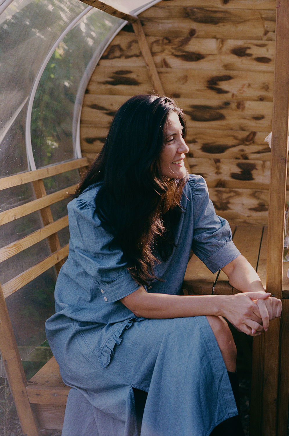 Woman wearing Rosa Japanese denim shirtdress showing ruffle pocket detail