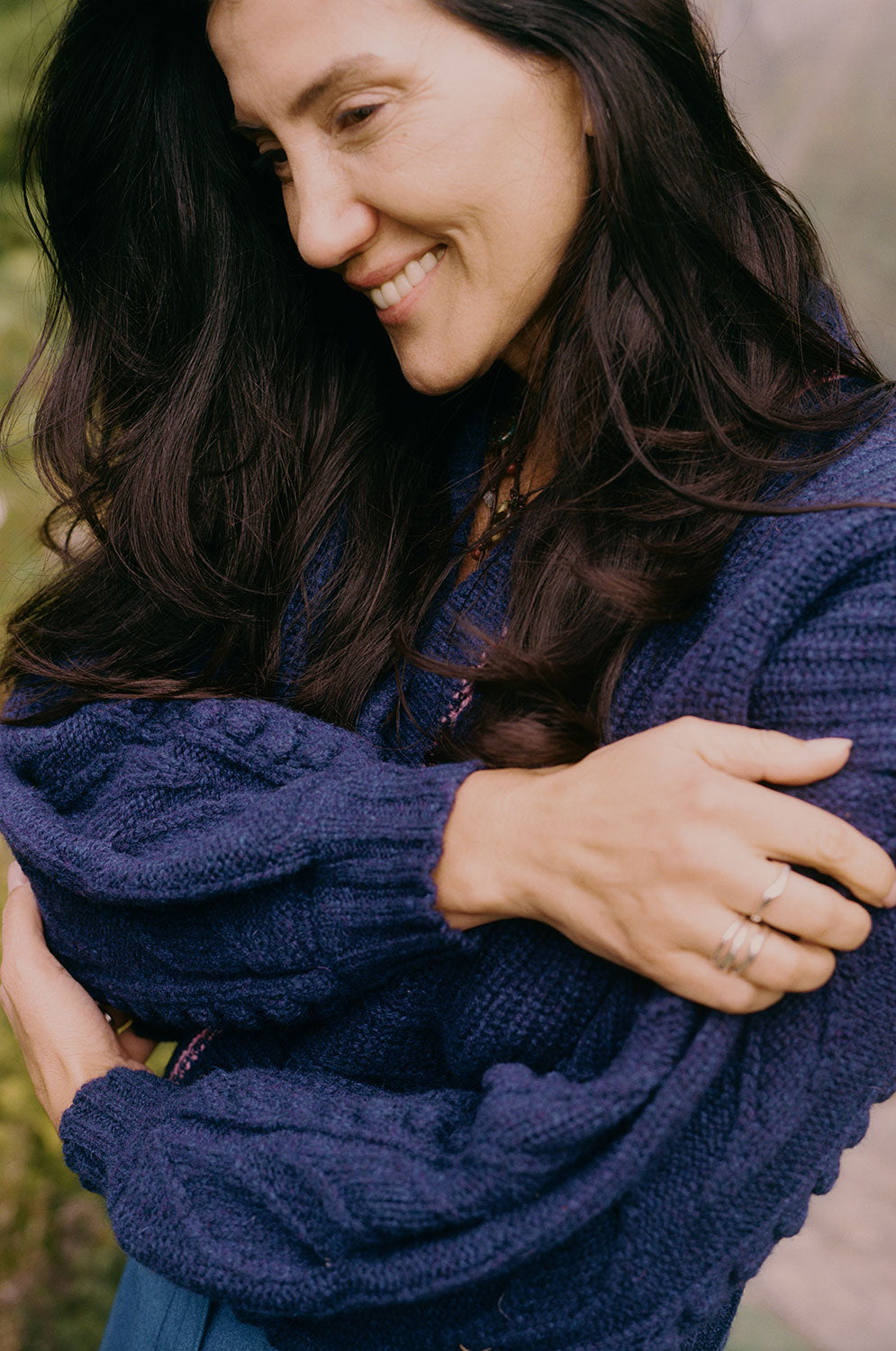 Close-up of Frida navy cardigan balloon sleeves with hand-finished leaf detail, 100% lambswool made in the UK