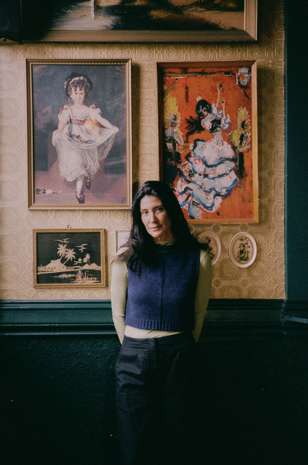 Model wearing midnight navy lambswool Ada Sweater Vest. Boxy fit knitted tank with textured half-purl, half-jersey stitch, made in the UK by Saywood.