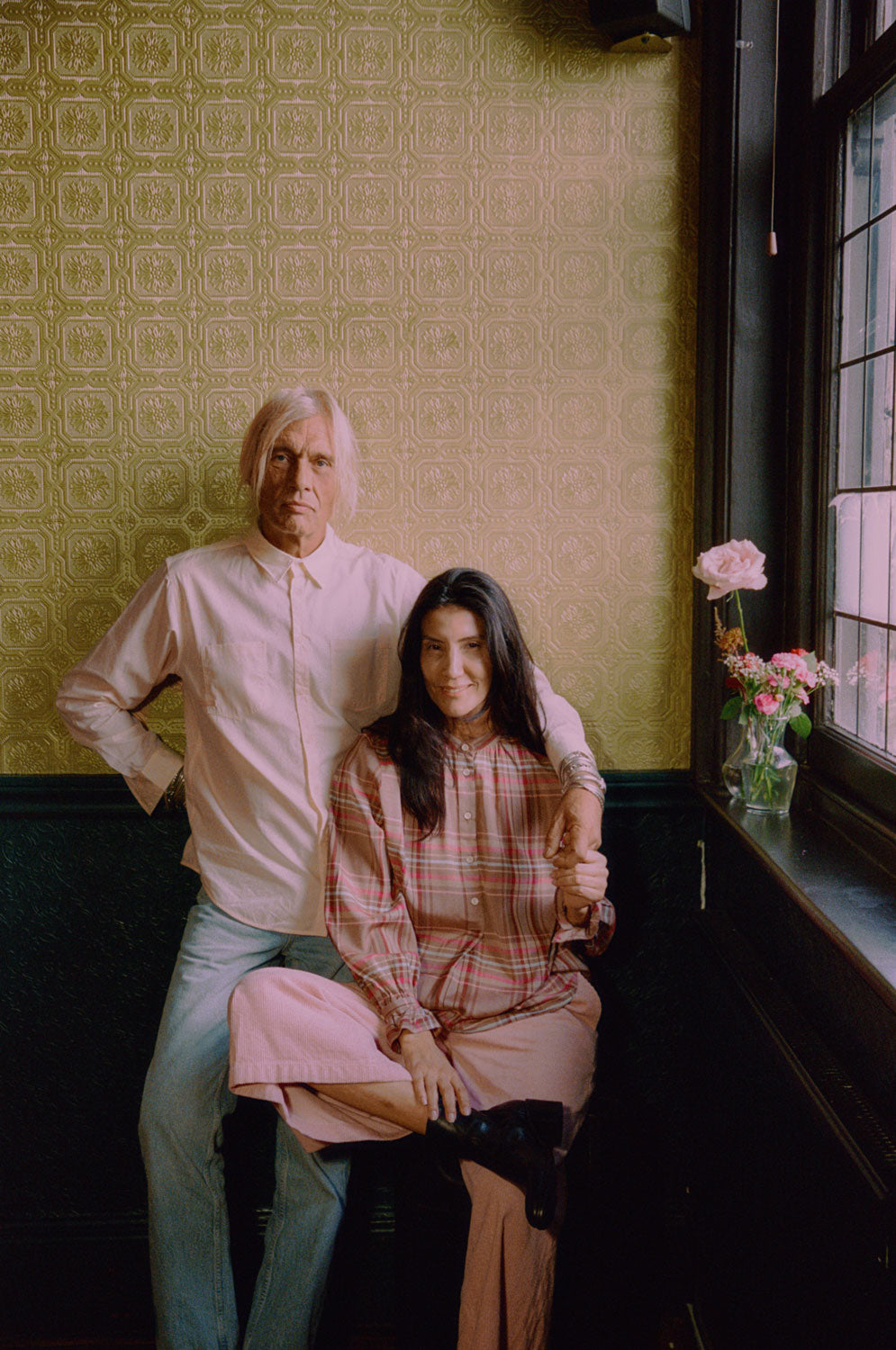 Eddy men's patchwork shirt in orange and lemon cotton, relaxed fit, handmade in London by Saywood. Woman wears Marie pink check blouse.