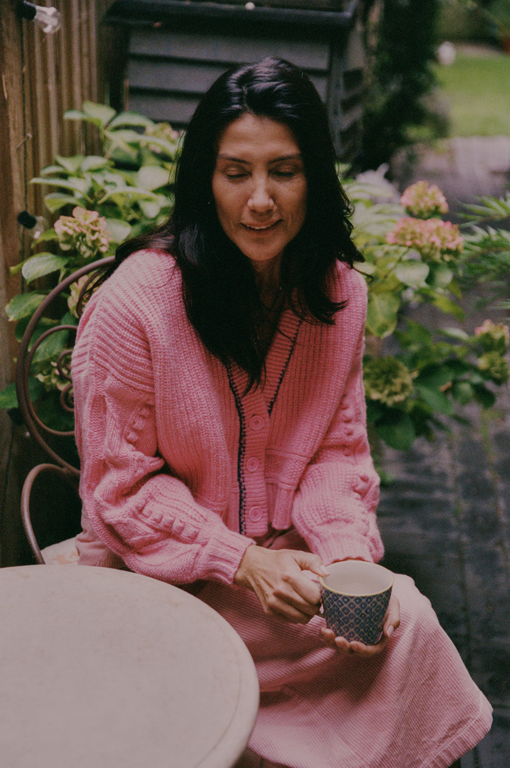 Close-up of Frida pink cardigan showing hand-finished balloon sleeve detail with leaf design