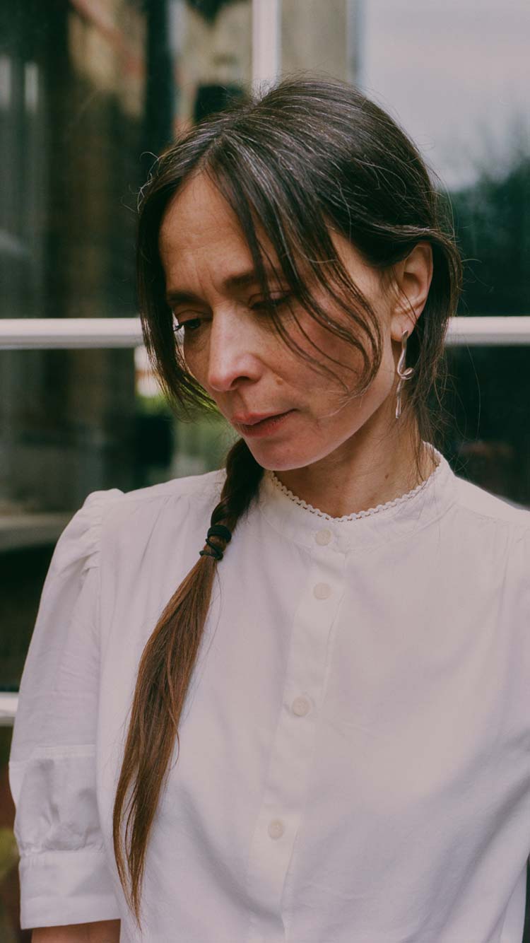 Joni Puff Sleeve Blouse in white, worn with delicate gold jewellery — sustainable womenswear made in England by Saywood