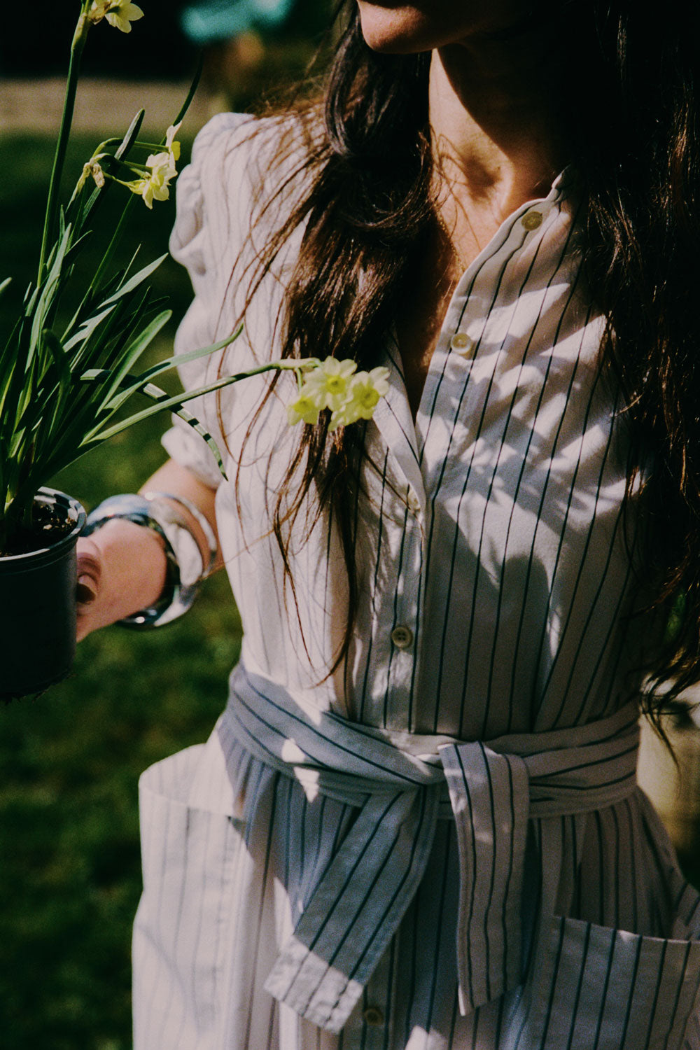 Close-up detail of Rosa puff sleeve shirtdress in white cotton pinstripe with detachable belt by Saywood