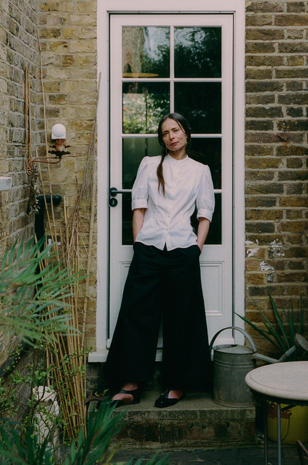 Styling inspiration: Joni white puff sleeve blouse styled with black Amelia trousers, made in London by Saywood