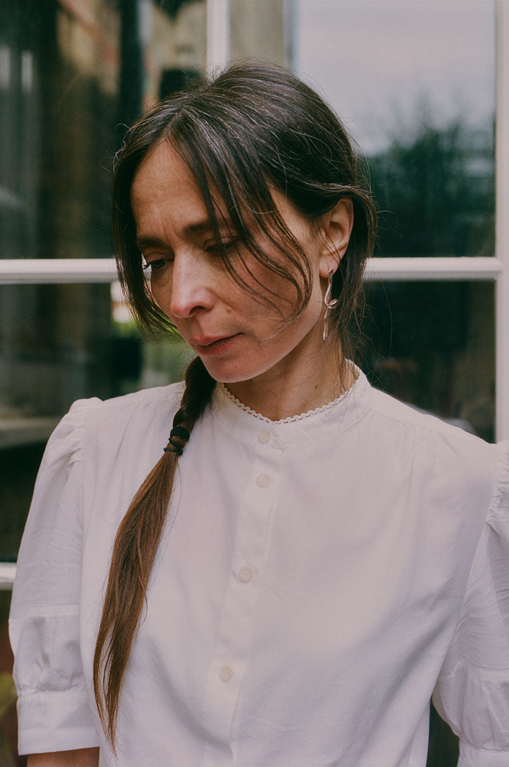 Close-up detail of Joni blouse lace collar trim and puff sleeves in white cotton bamboo, made in London by Saywood