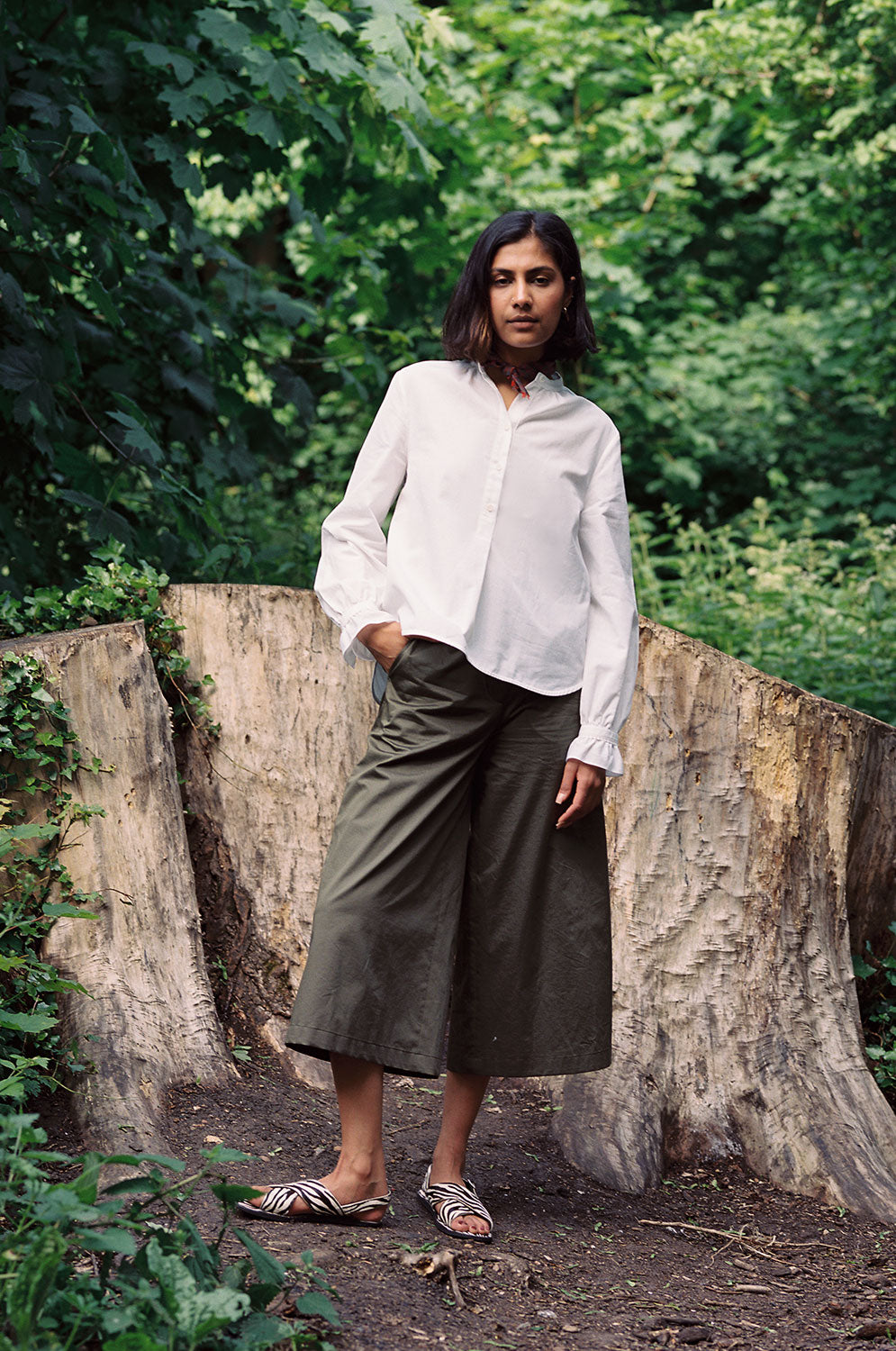 Marie white A-line blouse with red check neckerchief, made in London by Saywood. Worn with Amelia khaki wide leg trousers.