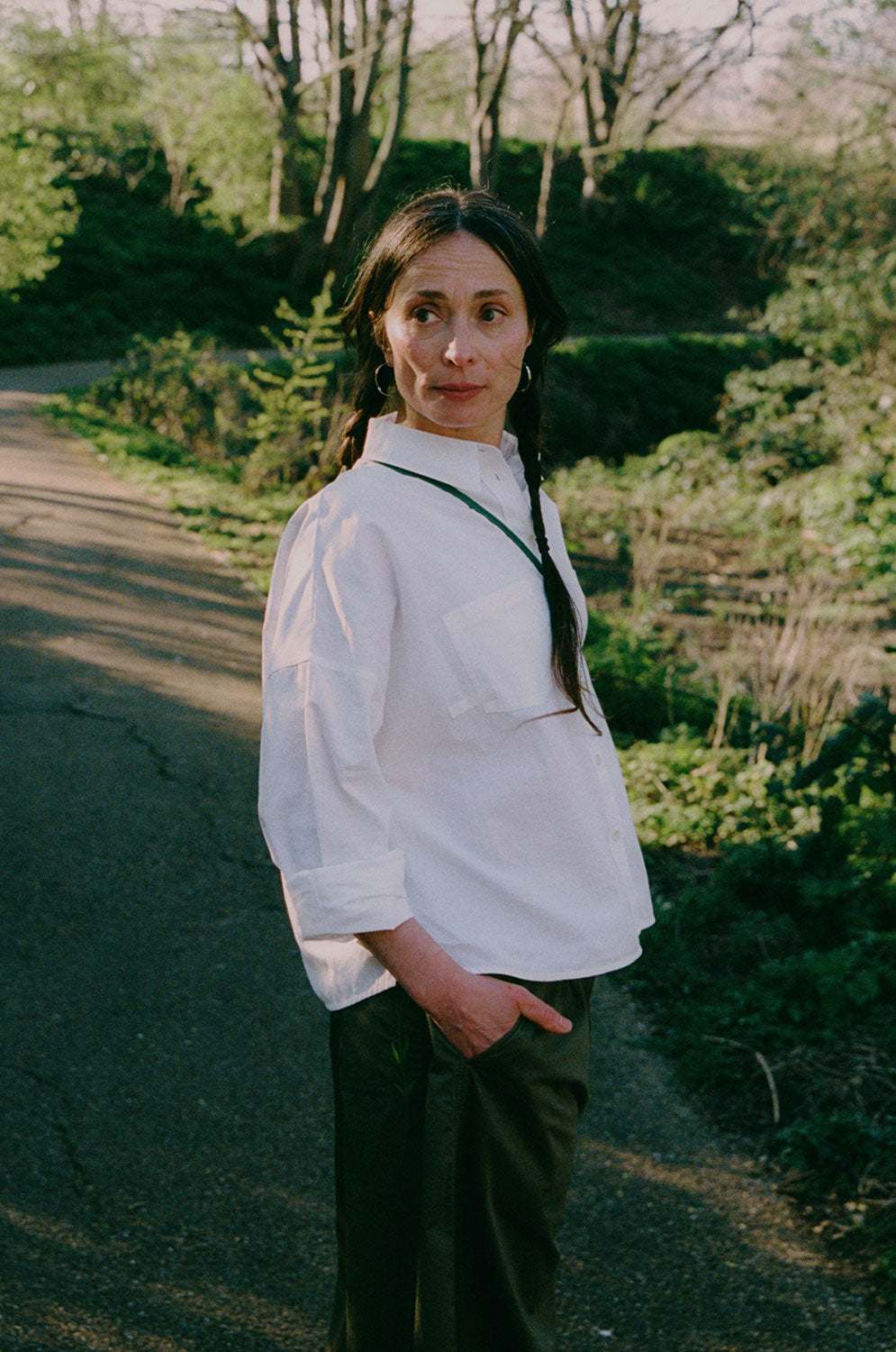 Styling inspiration: Lela white recycled cotton shirt paired with khaki Amelia wide leg trousers, outdoor lifestyle shot by Saywood