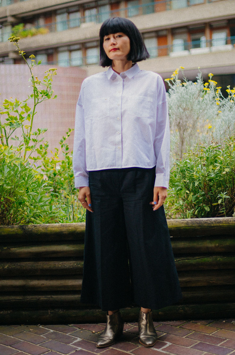 Lela white recycled cotton shirt styled with black Amelia wide leg trousers, sustainable British fashion by Saywood
